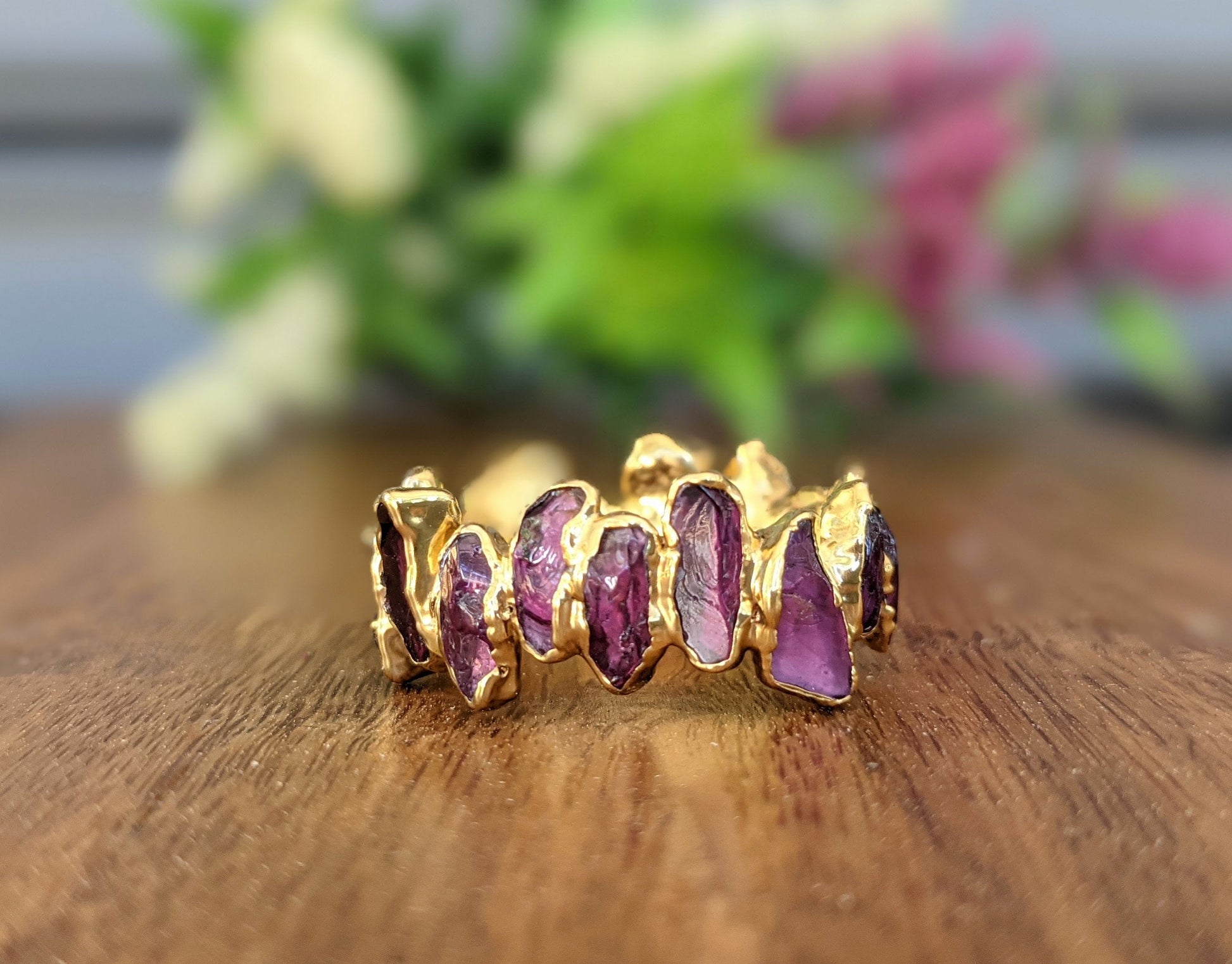 Raw Rhodolite Garnet Eternity Ring featuring gold filled band with unique gemstone shapes.