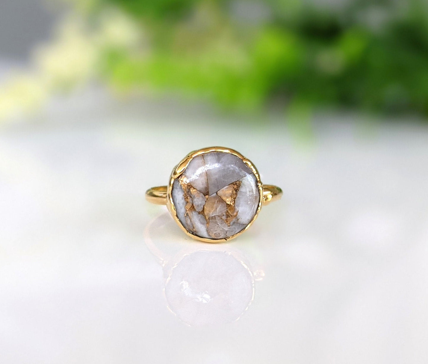 White Crystal and Copper ring set on an 18k Gold plated band, featuring a unique 12mm round gemstone.