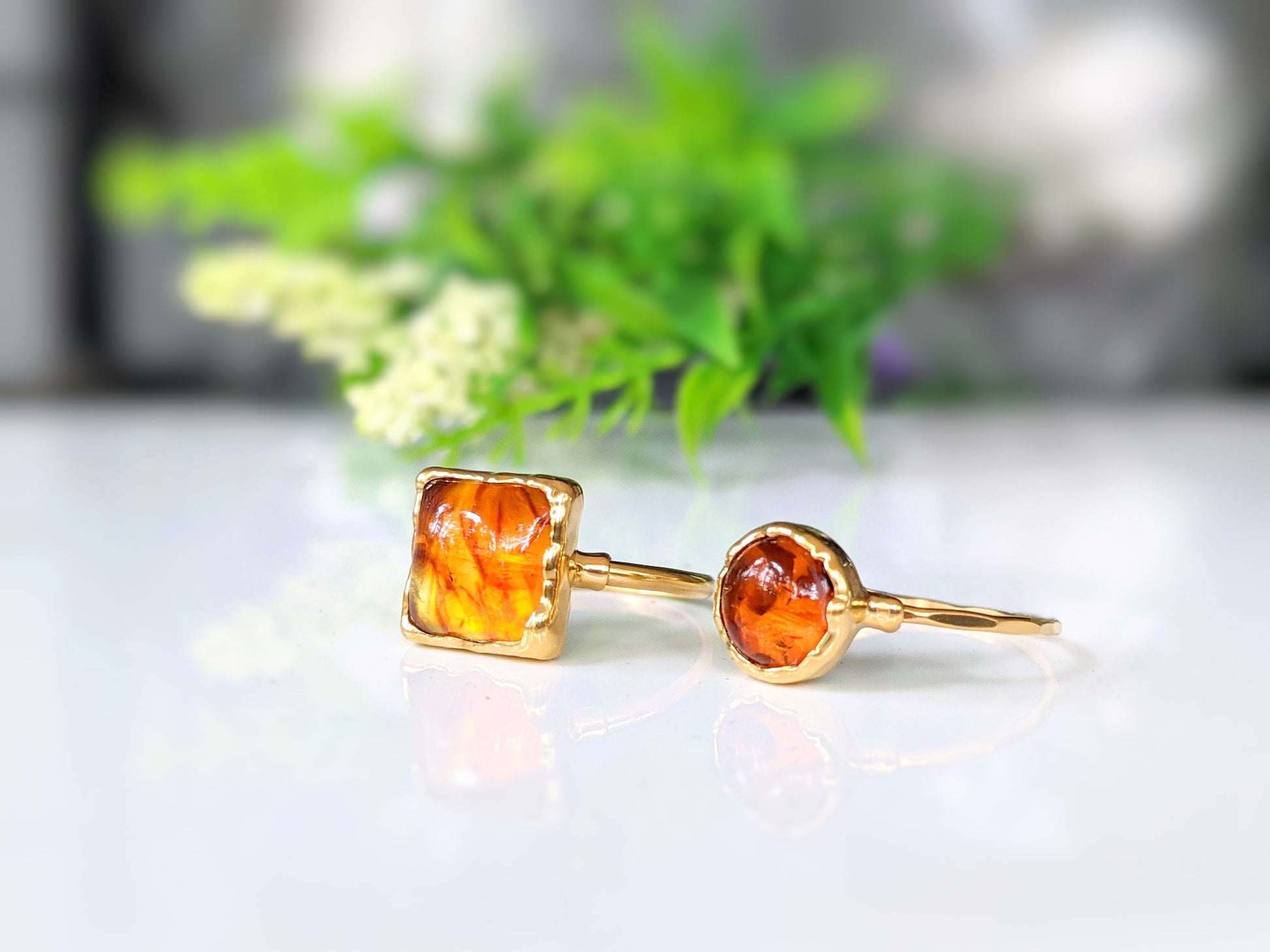 Square Baltic Amber gold ring featuring honey color stone on a 14k gold filled band, showcasing unique natural details.