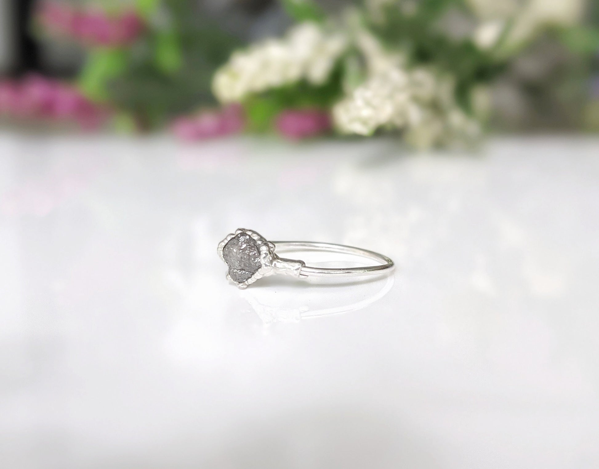 Handcrafted raw uncut grey diamond engagement ring on a sterling silver band, perfect for unique proposals.