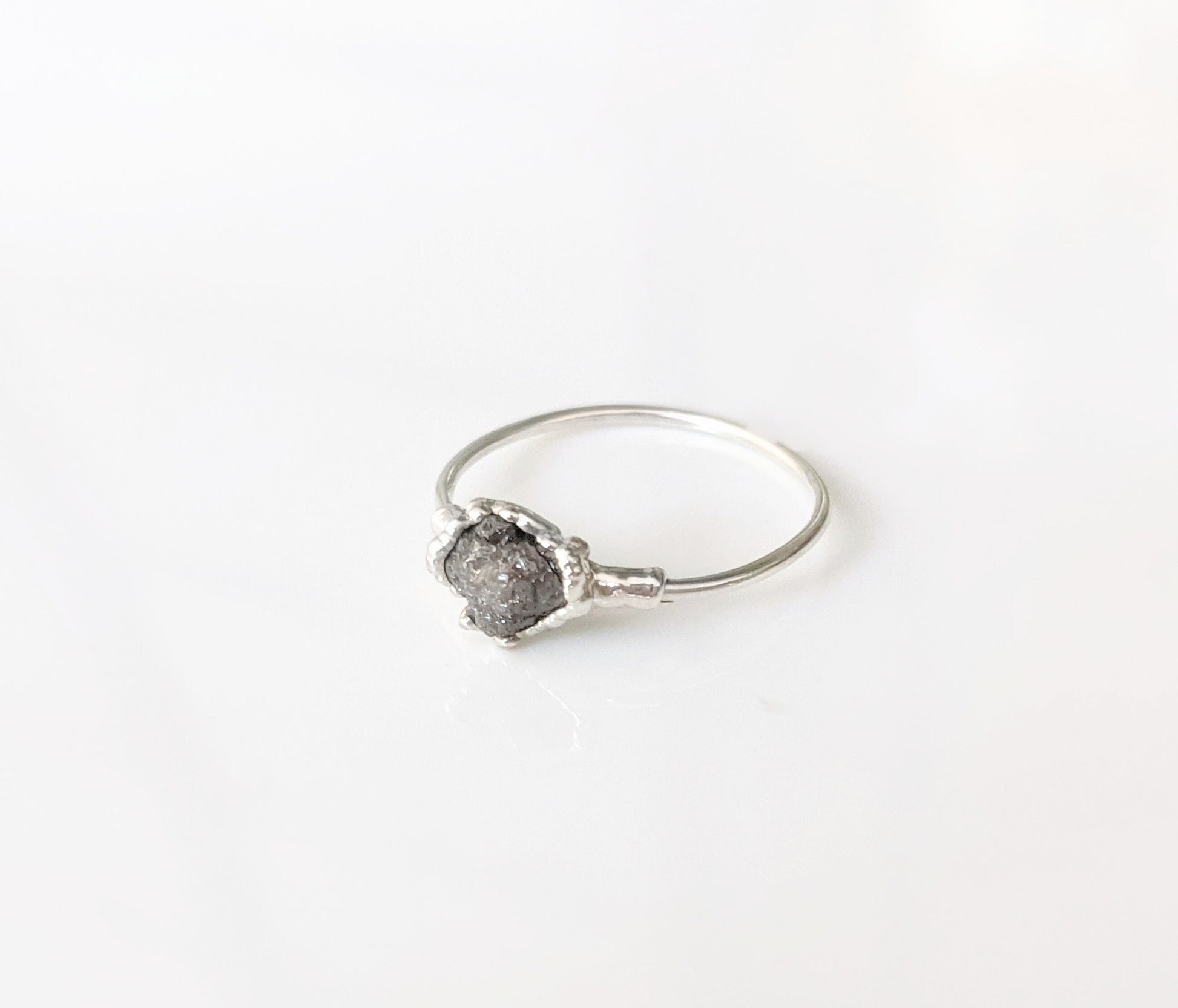 Unique raw uncut grey diamond engagement ring set on a sterling silver band, perfect for alternative proposals.