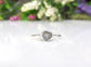 Handcrafted raw uncut grey diamond engagement ring on a sterling silver band with floral details.