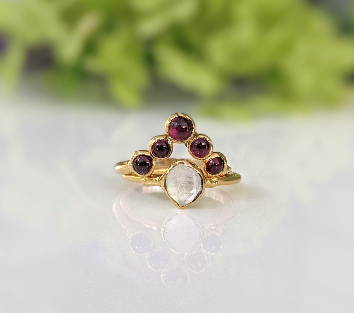 Ruby Chevron ring in 18k gold featuring natural rubies and a pear-cut stone, perfect for celebrating love and special occasions.