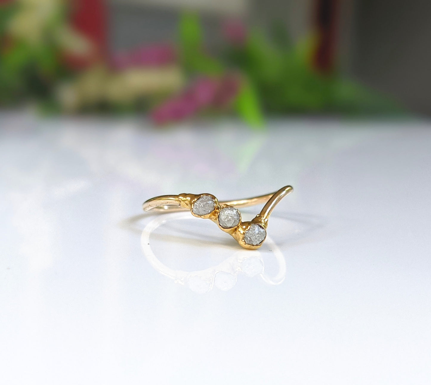 Delicate raw diamond Chevron ring in 18k gold, featuring three unique conflict-free diamonds, perfect for engagement.