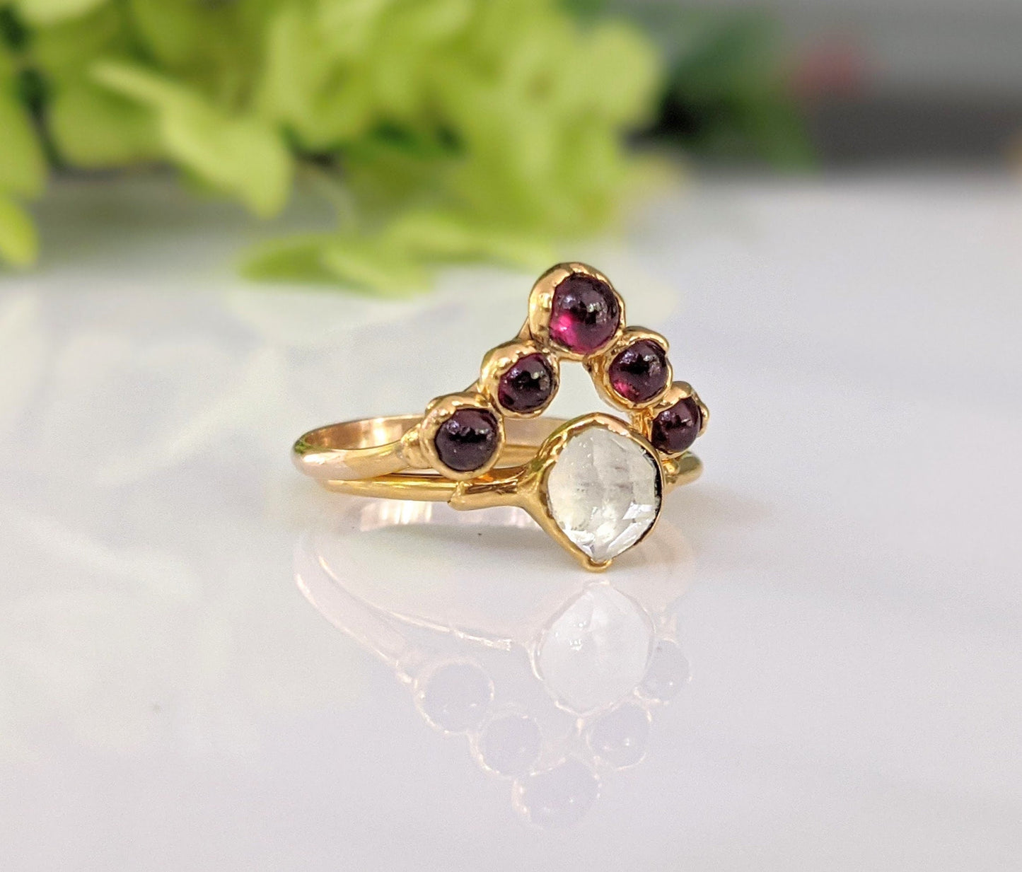 Ruby chevron ring in 18k gold with five rubies and a clear gemstone, perfect for celebrations of love.