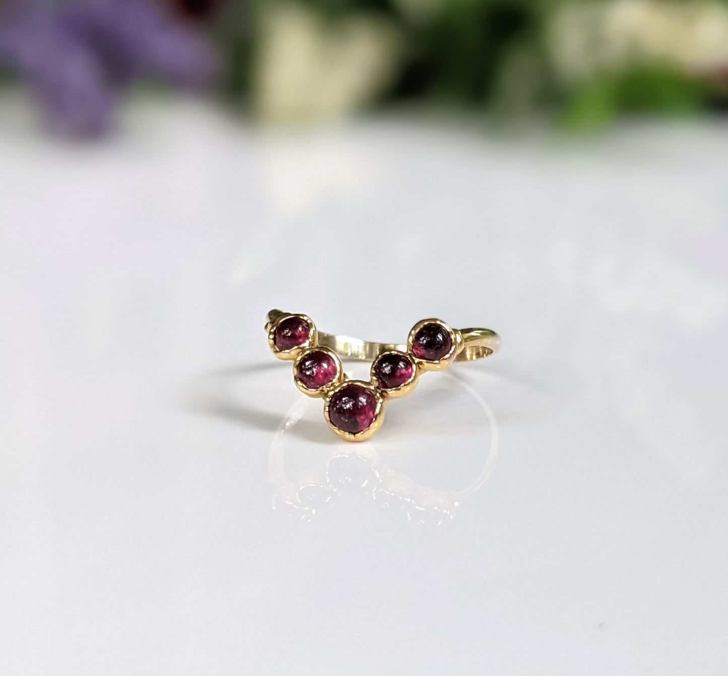 Handcrafted 18k gold chevron ring featuring natural rubies, perfect July birthstone wedding band.