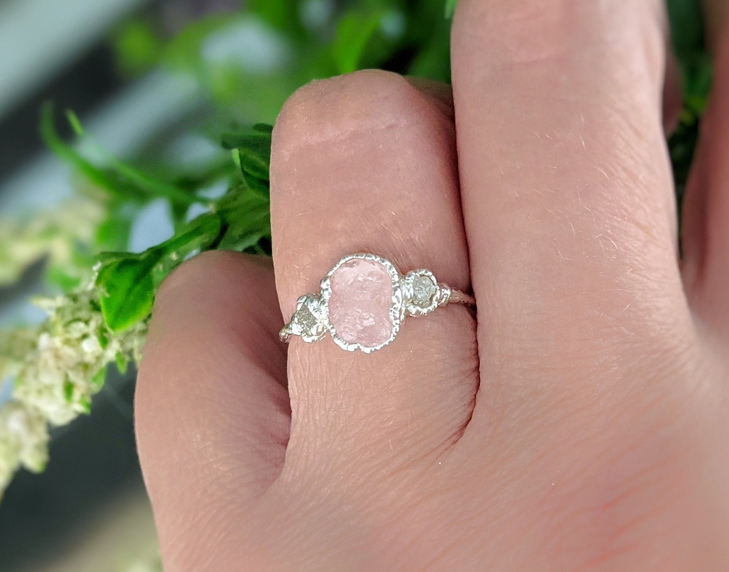 Raw Morganite ring on a hand, featuring a pink gemstone and natural diamonds on a sterling silver band.