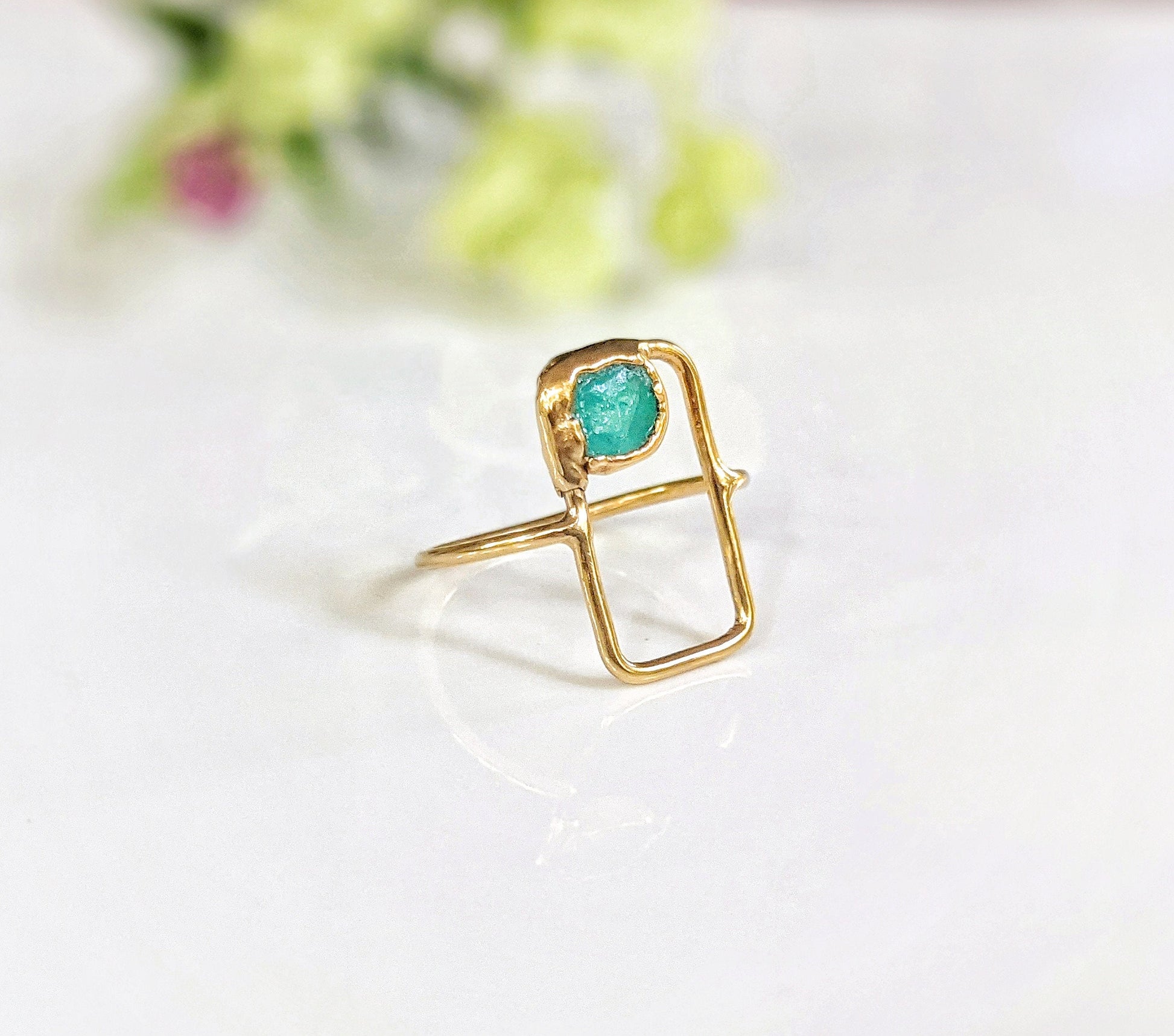 Raw Peruvian opal geometric ring with a natural blue opal set in a rectangular 14k gold band.