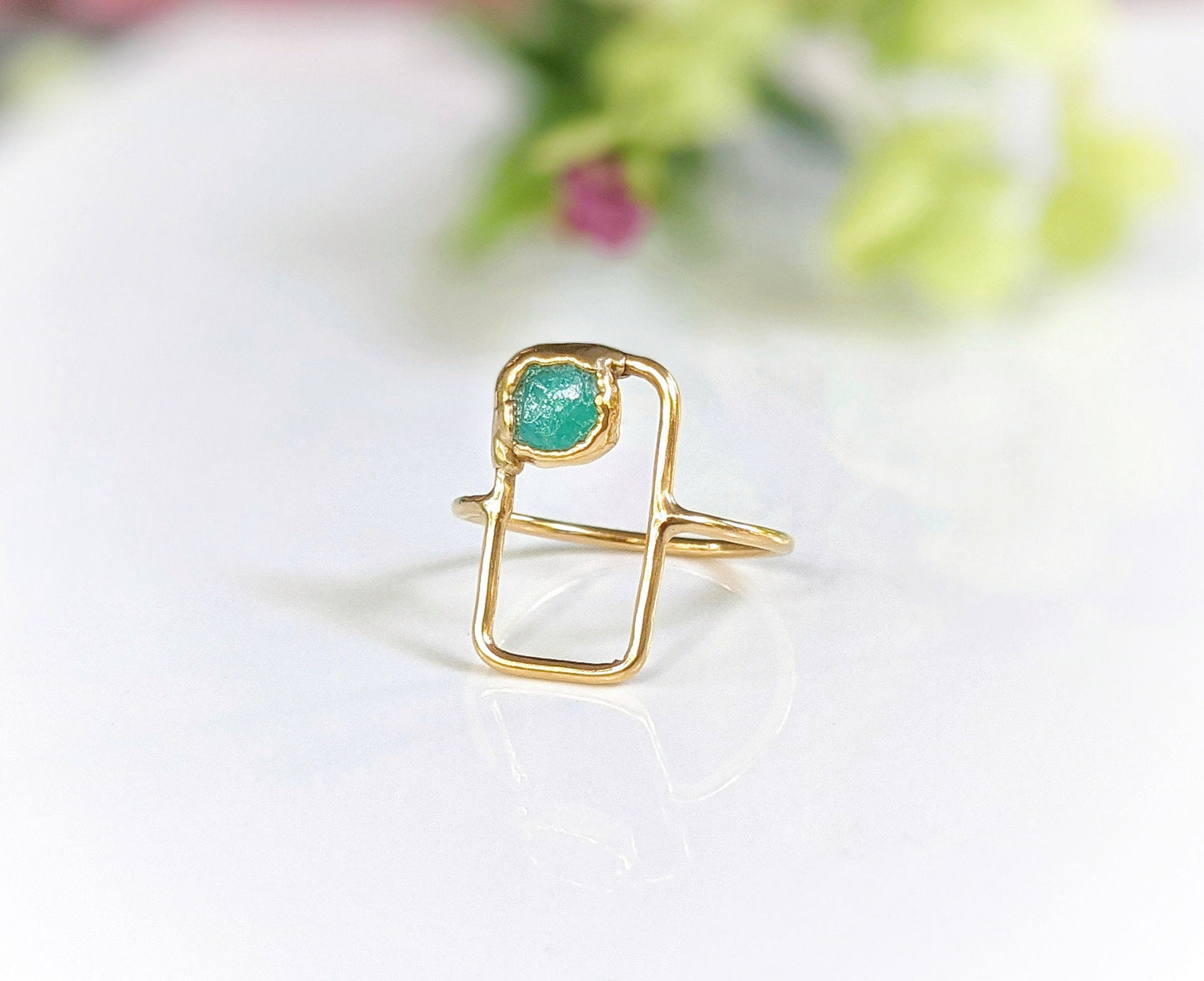 Modern geometric ring featuring raw blue Peruvian Opal set on a dainty 14k gold band.