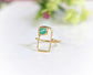 Modern geometric ring featuring raw blue Peruvian Opal set on a dainty 14k gold band.