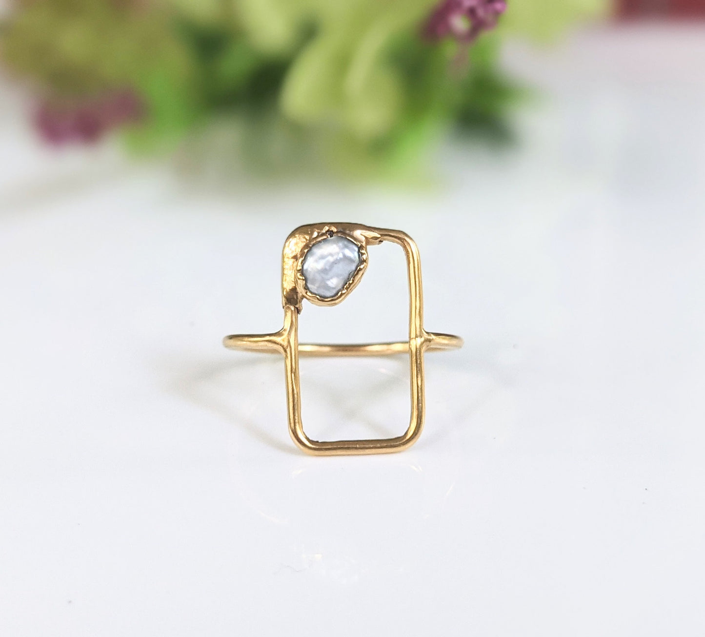 Geometric freshwater pearl ring in solid 14k gold with a unique design and natural pearl accent.
