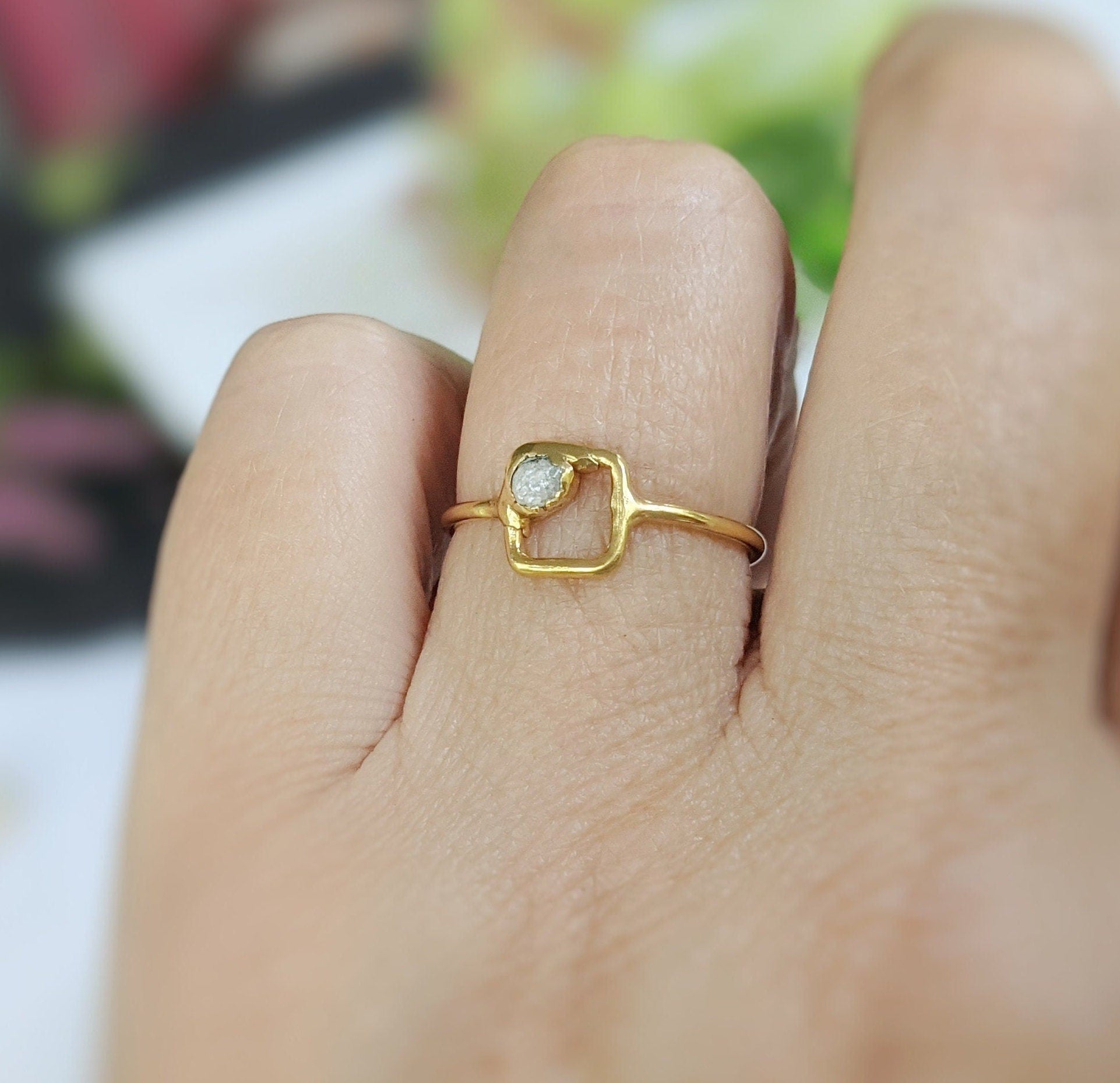 Minimalist solid gold square ring featuring a raw diamond, elegant design, and dainty appearance.