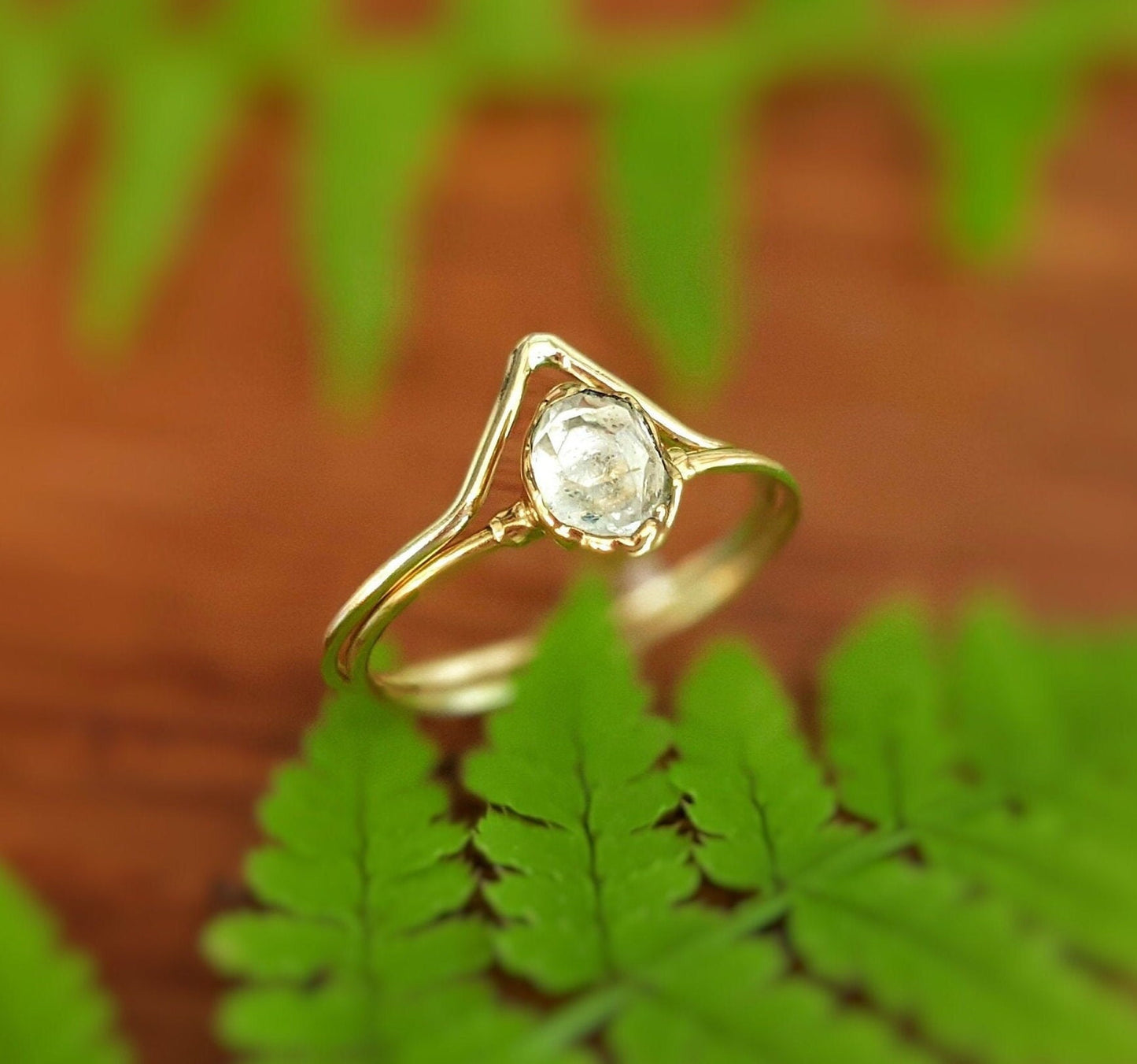 Herkimer diamond engagement ring set featured on green leaves, showcasing its unique design and handcrafted quality.