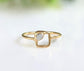 Minimalist solid gold ring featuring a unique raw diamond in a square setting.