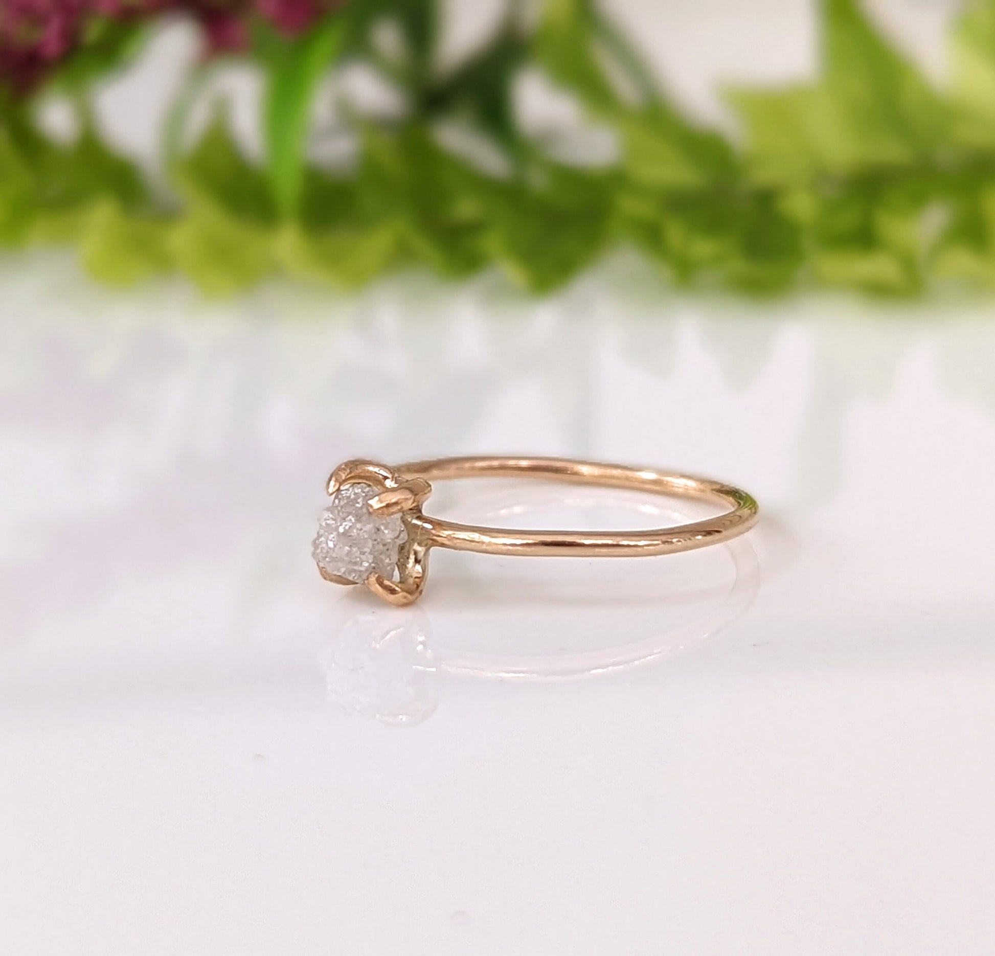 Delicate raw diamond engagement ring with 14k gold band, featuring a unique conflict-free diamond for timeless elegance.