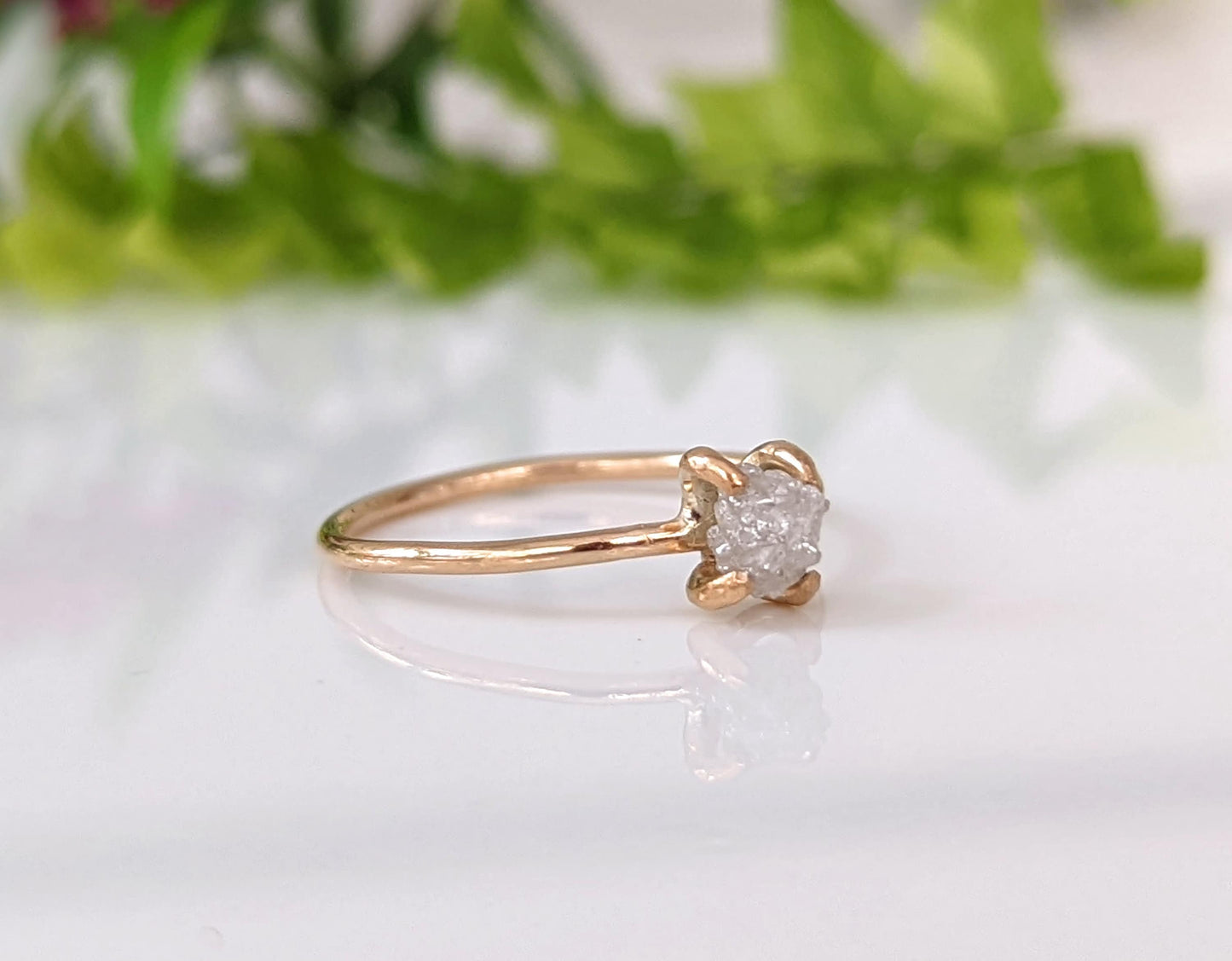 Delicate raw diamond engagement ring in 14k gold prong setting, perfect for timeless moments.