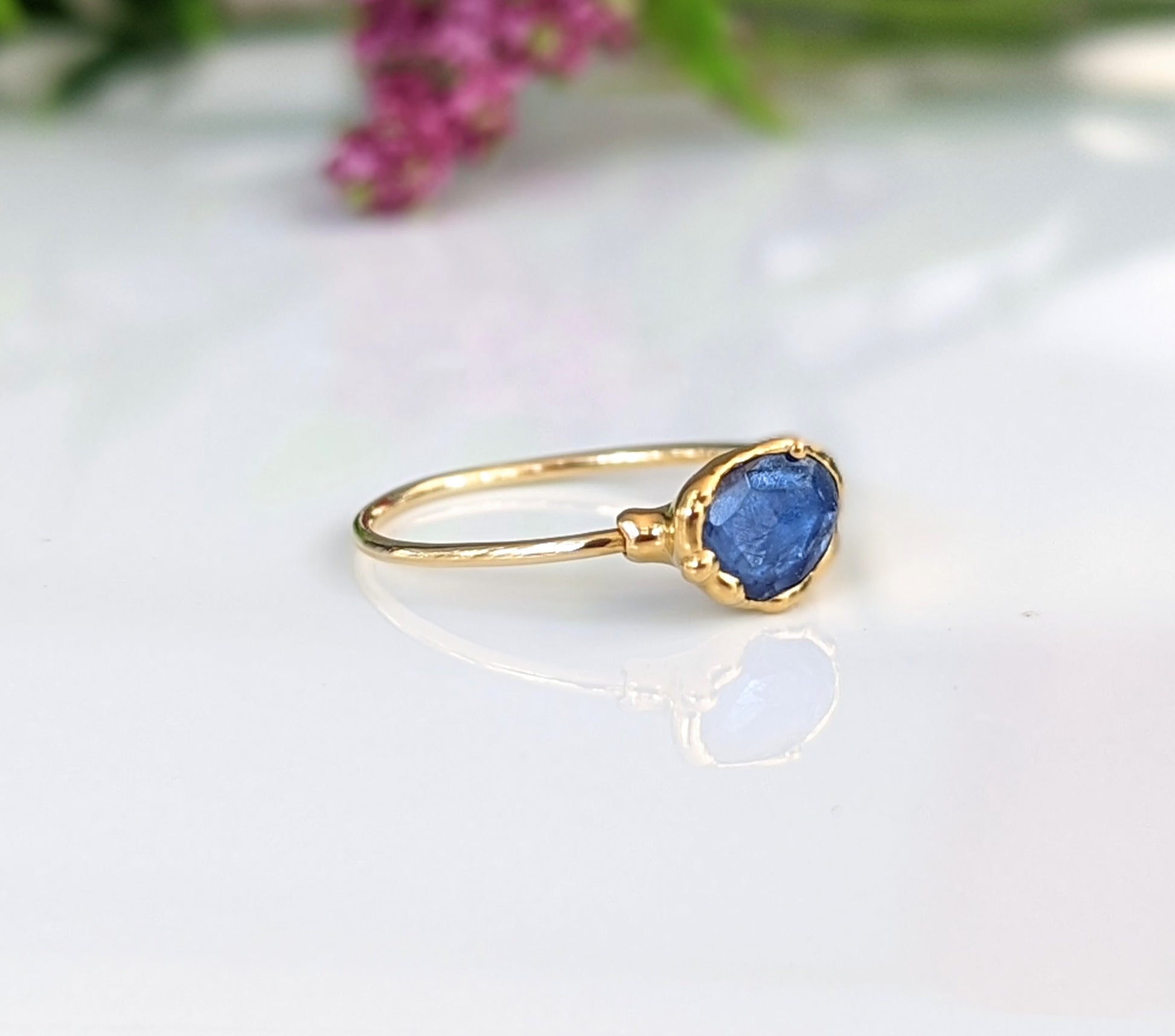 Blue rose-cut Kyanite stone set in a solid 14k gold band, showcasing a unique and elegant design.
