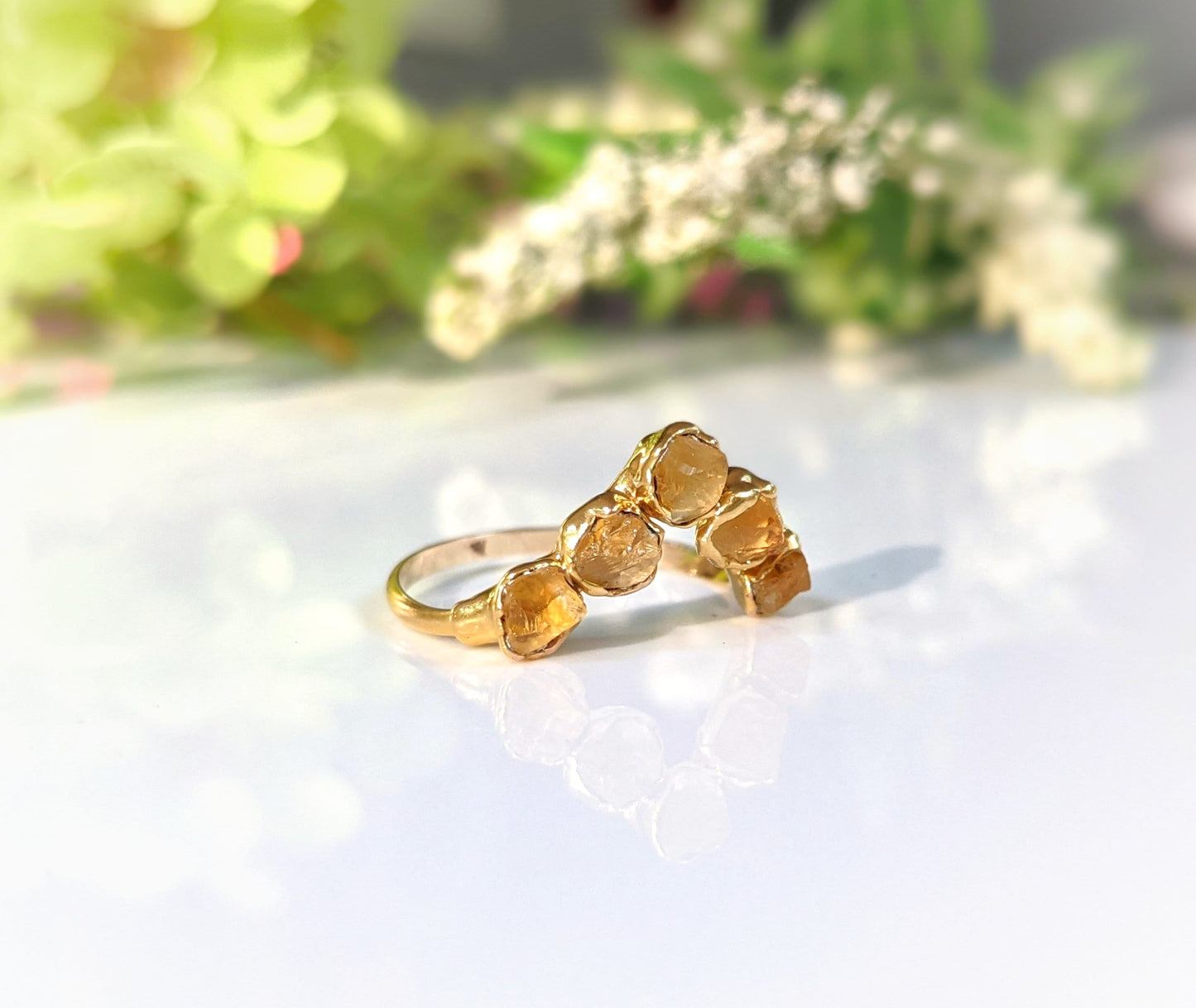 Raw Citrine Chevron ring set on a gold band, featuring five unique Citrine stones. Perfect November birthstone gift.