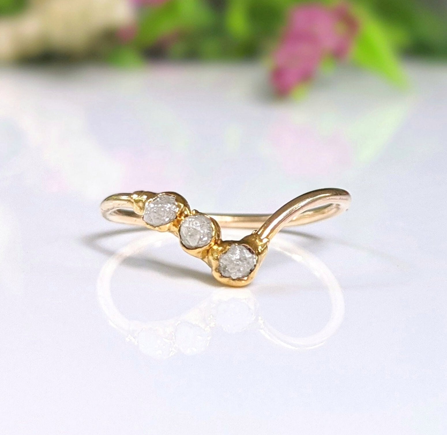 Raw diamond Chevron engagement ring in 18k gold with three conflict-free diamonds, showcasing unique and delicate design.