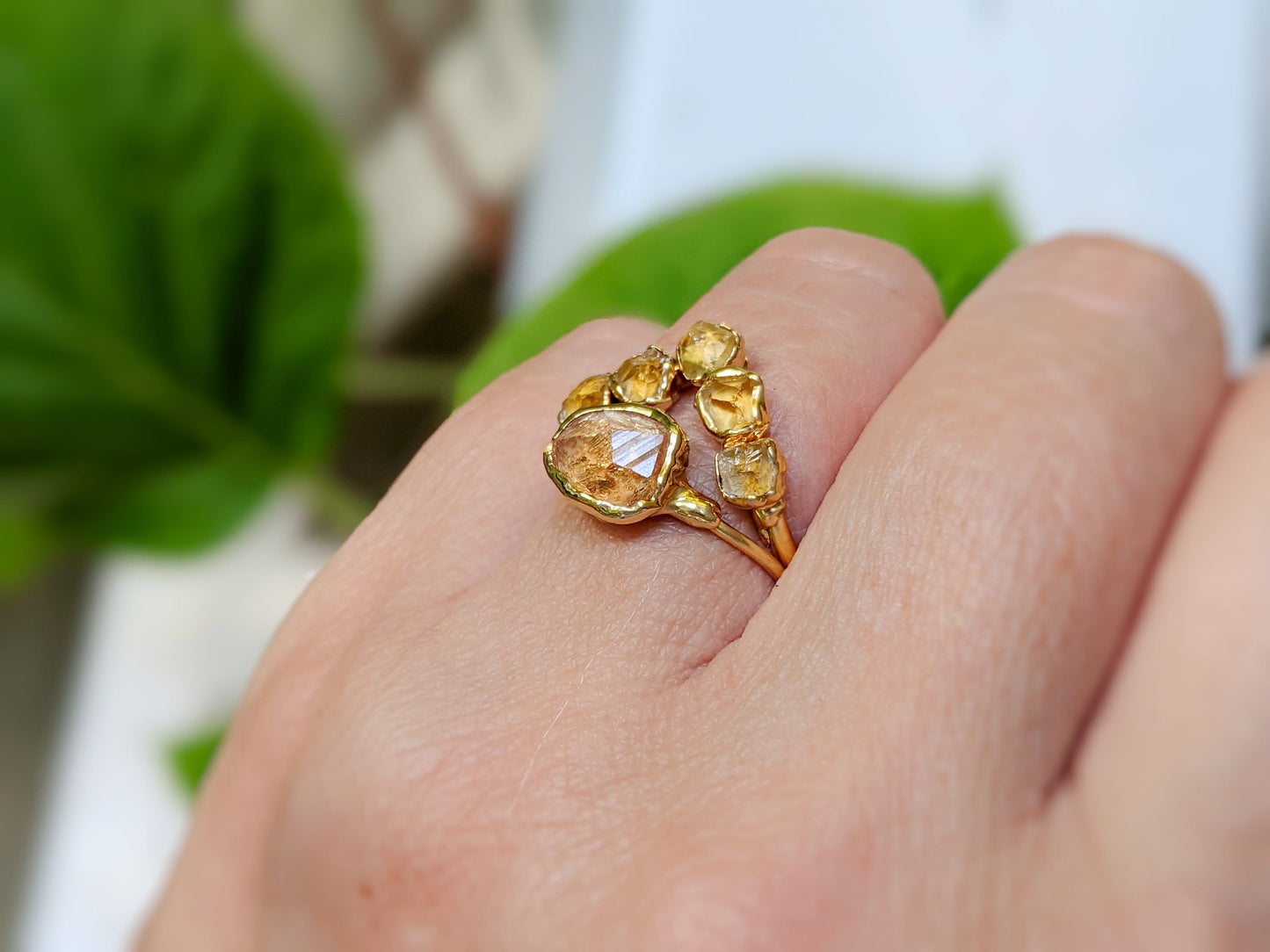 Raw Topaz and Citrine Chevron ring set on a hand, featuring five Citrine stones and a unique design.