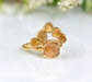 Raw Topaz and Citrine Chevron ring set on a white background, featuring golden gems in a unique design.