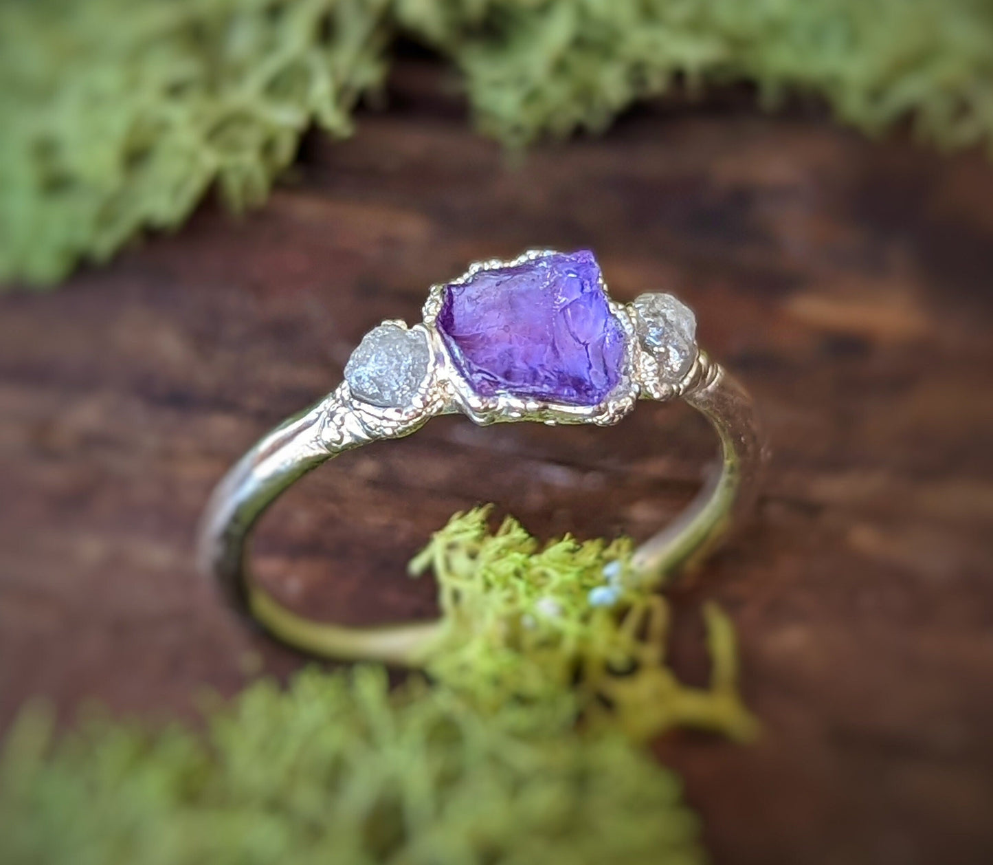 Raw Amethyst and rough diamond ring on a natural backdrop, handcrafted sterling silver with a unique design.