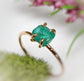 Raw emerald solitaire ring in solid 14k gold, showcasing elegant craftsmanship and natural beauty.