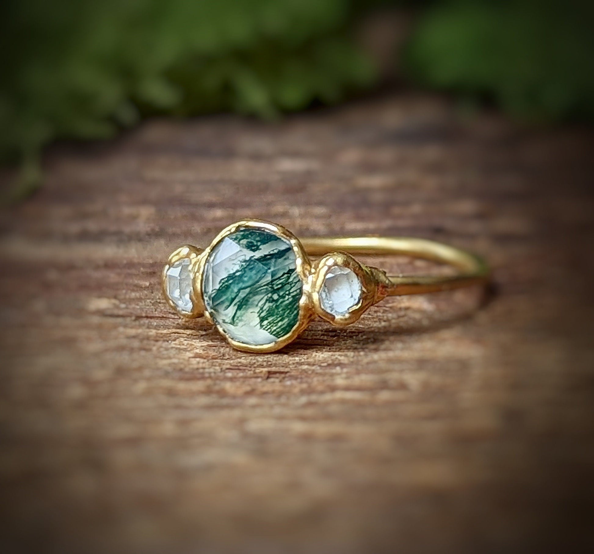 Moss Agate ring with Herkimer diamonds, set on an 18k gold band, showcasing unique craftsmanship and natural beauty.