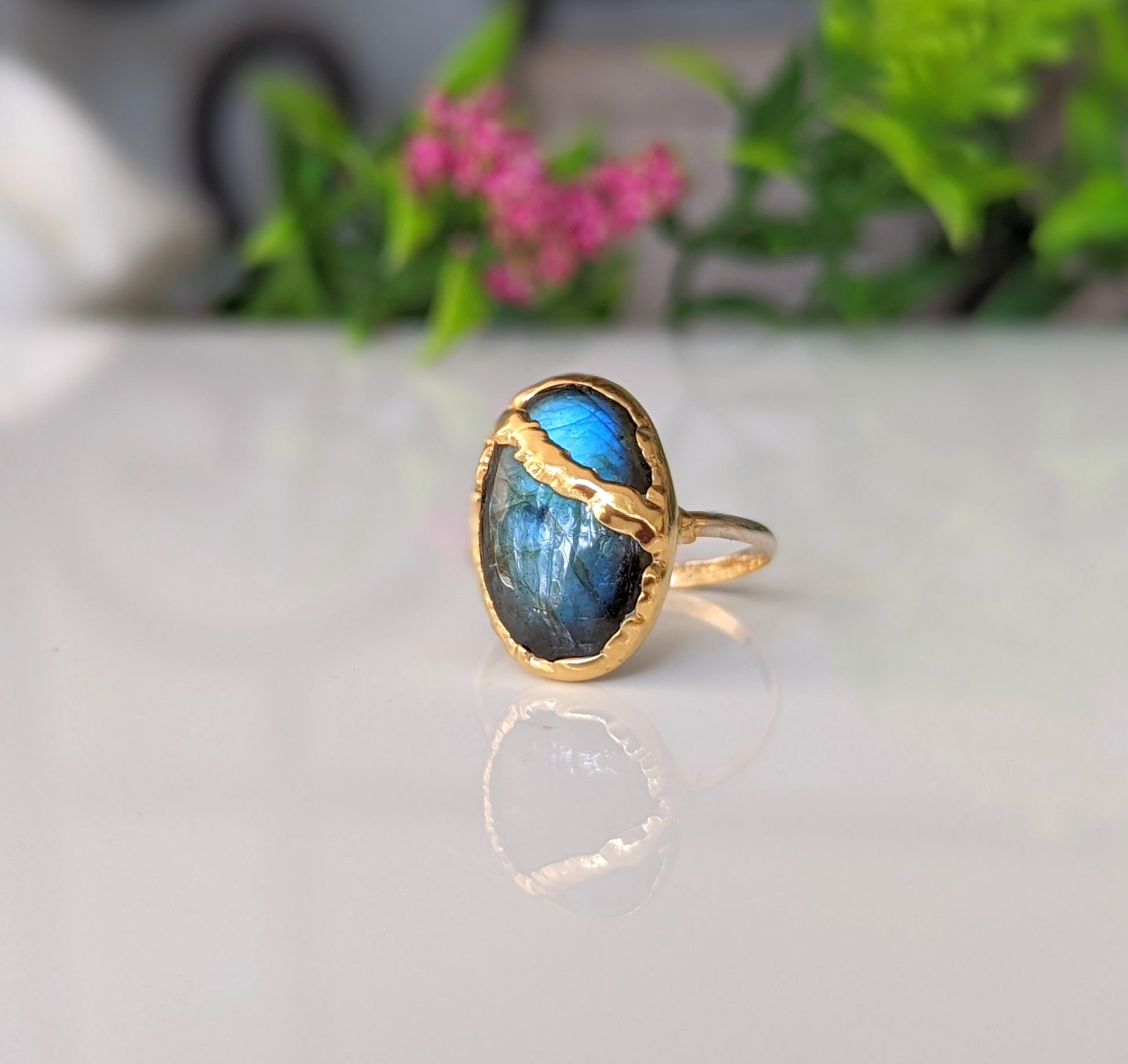 Labradorite Kintsugi ring featuring a blue stone set in 18k gold-plated electroformed band, symbolizing inner light.
