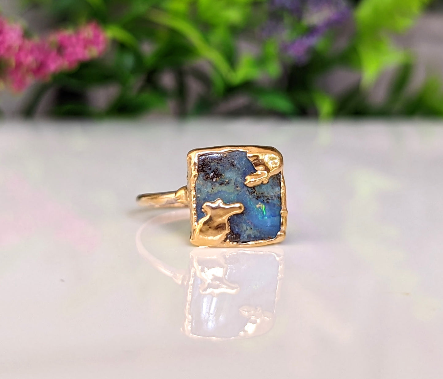 Australian Opal Kintsugi ring on a gold band, showcasing unique artistic imperfections and vibrant colors.