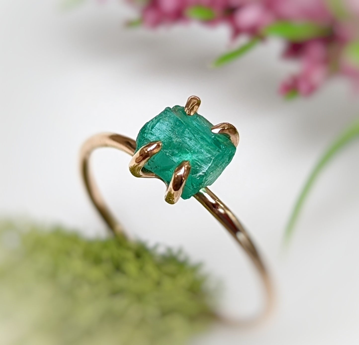 Natural raw emerald solitaire ring in solid 14k gold, showcasing unique elegance and handcrafted beauty.