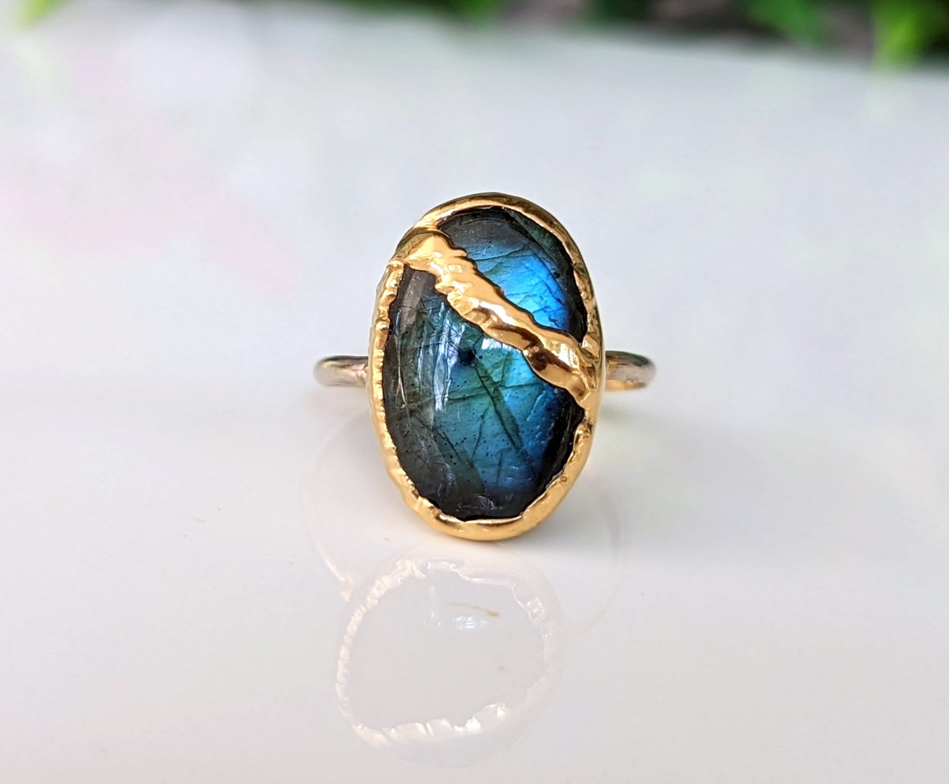 Labradorite Kintsugi ring with gold accents, showcasing a stunning blue sheen set on a 14k gold-filled band.