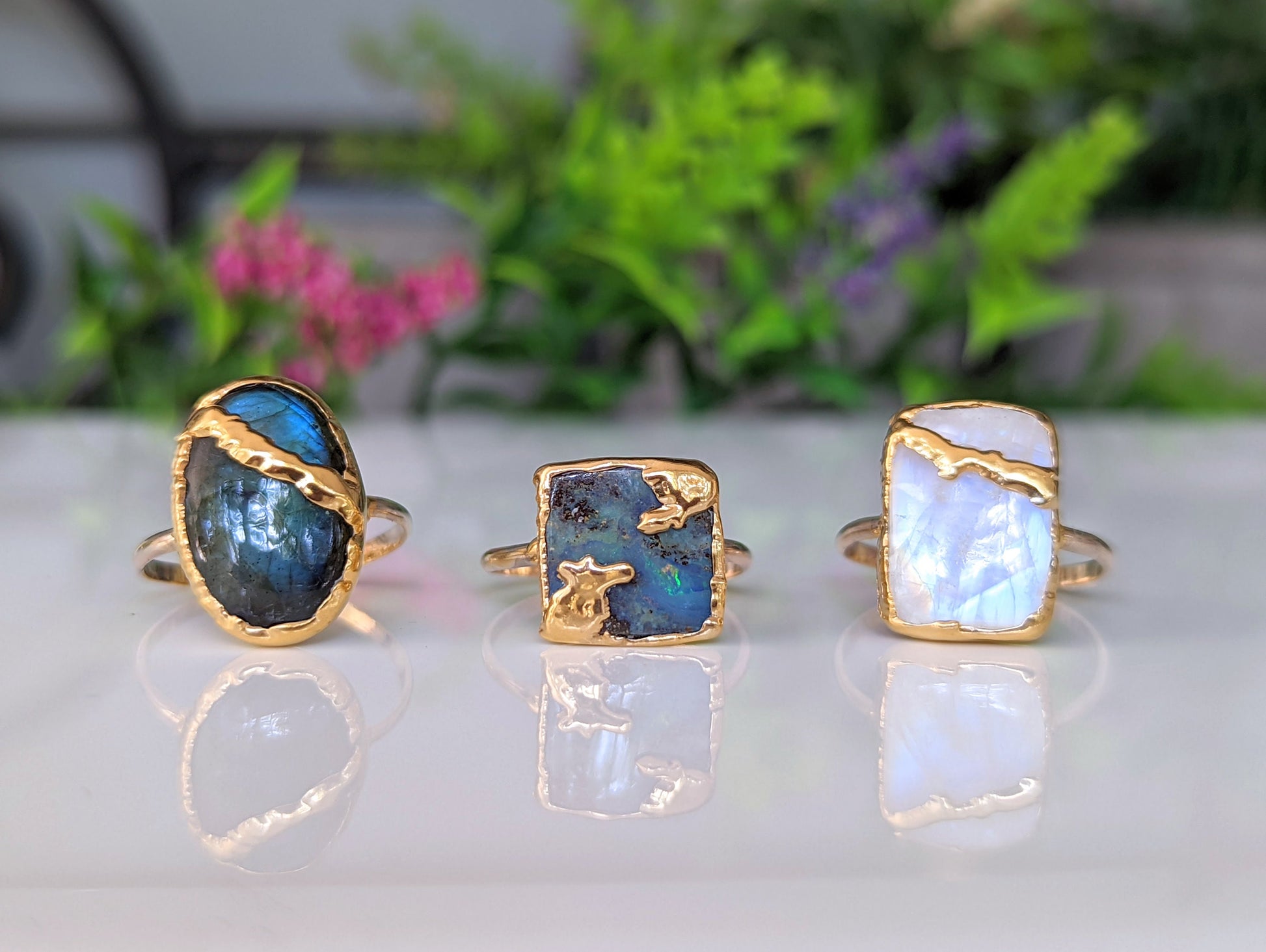 Handcrafted Kintsugi rings featuring Rainbow Moonstone, labradorite, and peacock opal in gold settings.