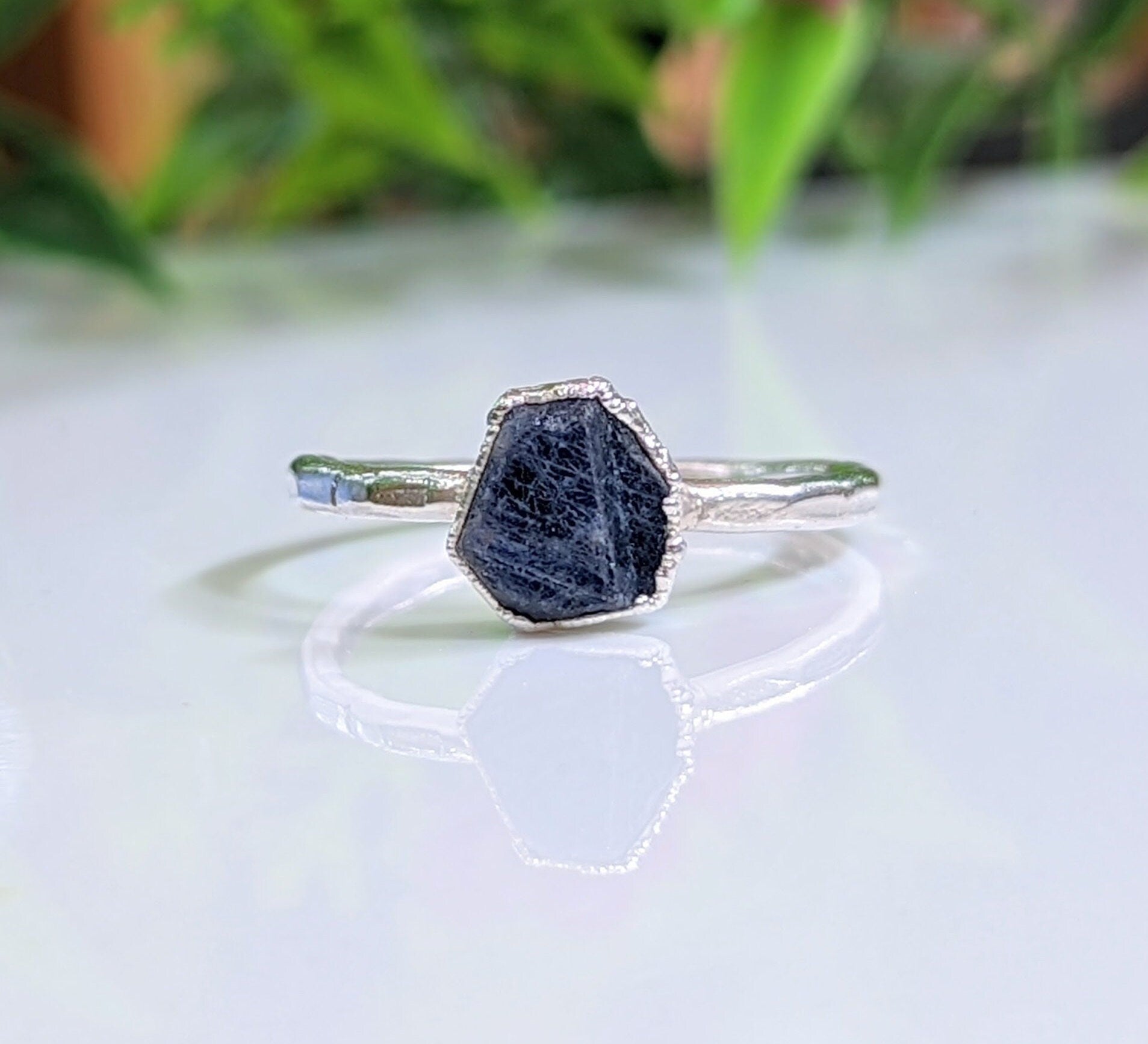 Handcrafted raw sapphire ring on silver band, perfect for nature lovers and September birthdays.