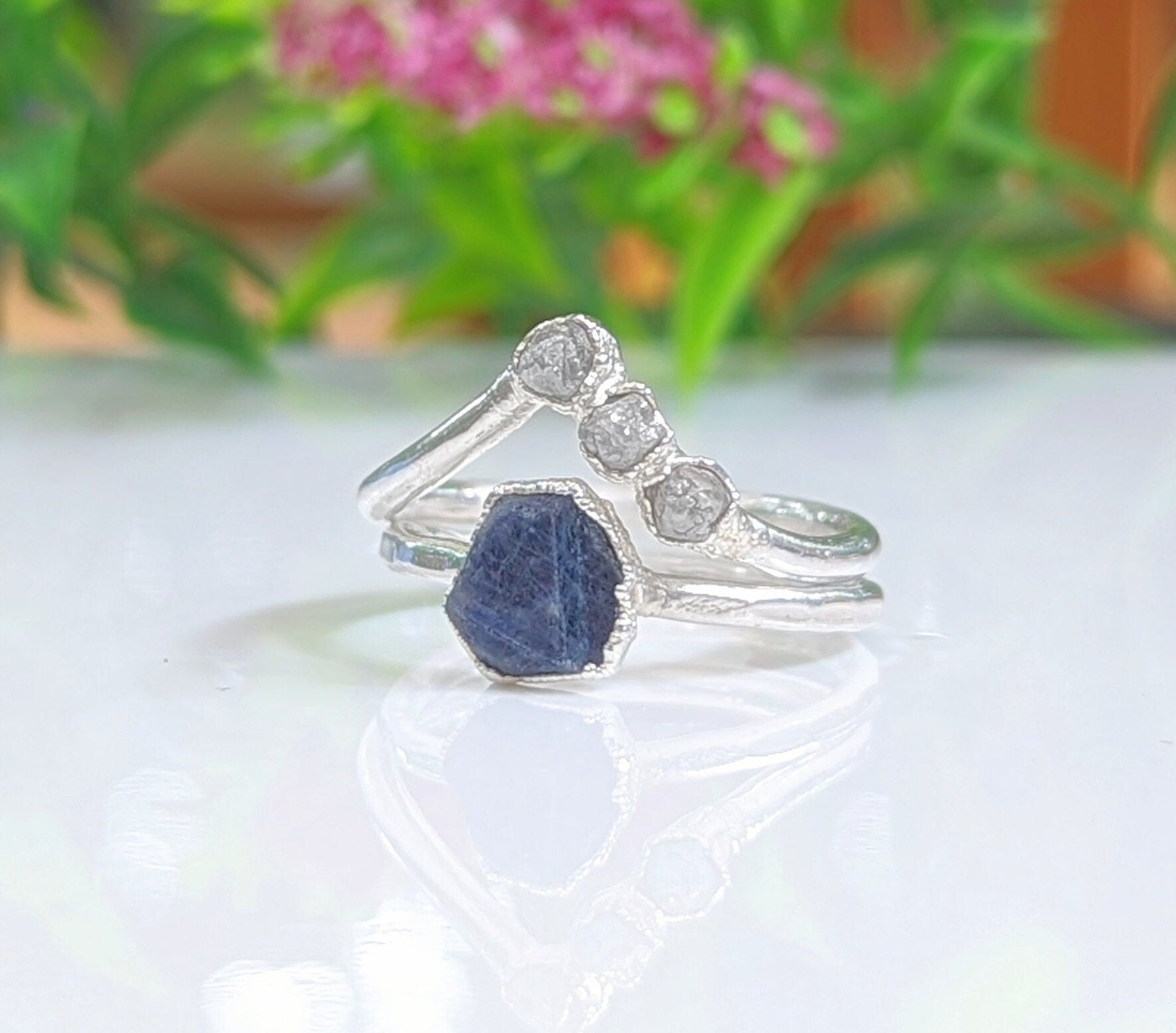 Raw sapphire and diamond chevron wedding ring set on sterling silver bands, showcasing a rustic and timeless design.