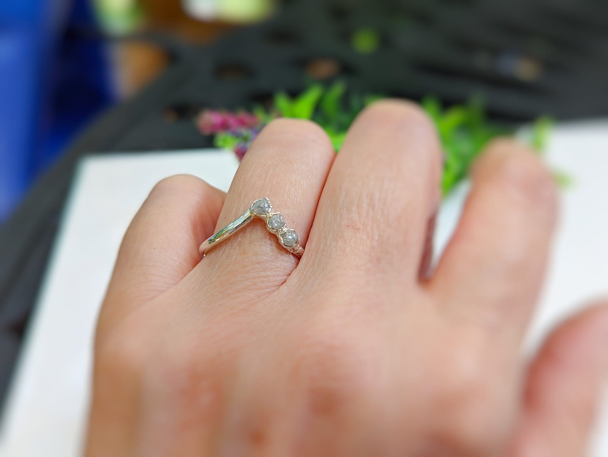 Handcrafted raw diamond chevron ring set on a hand, showcasing unique design and natural beauty.