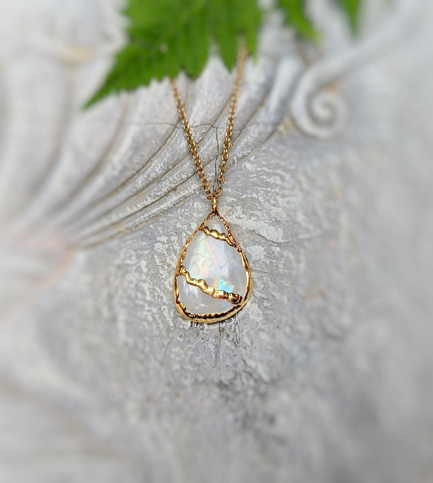 Kintsugi style necklace featuring large pear-shaped rainbow Moonstone set in 18k gold on a chain.