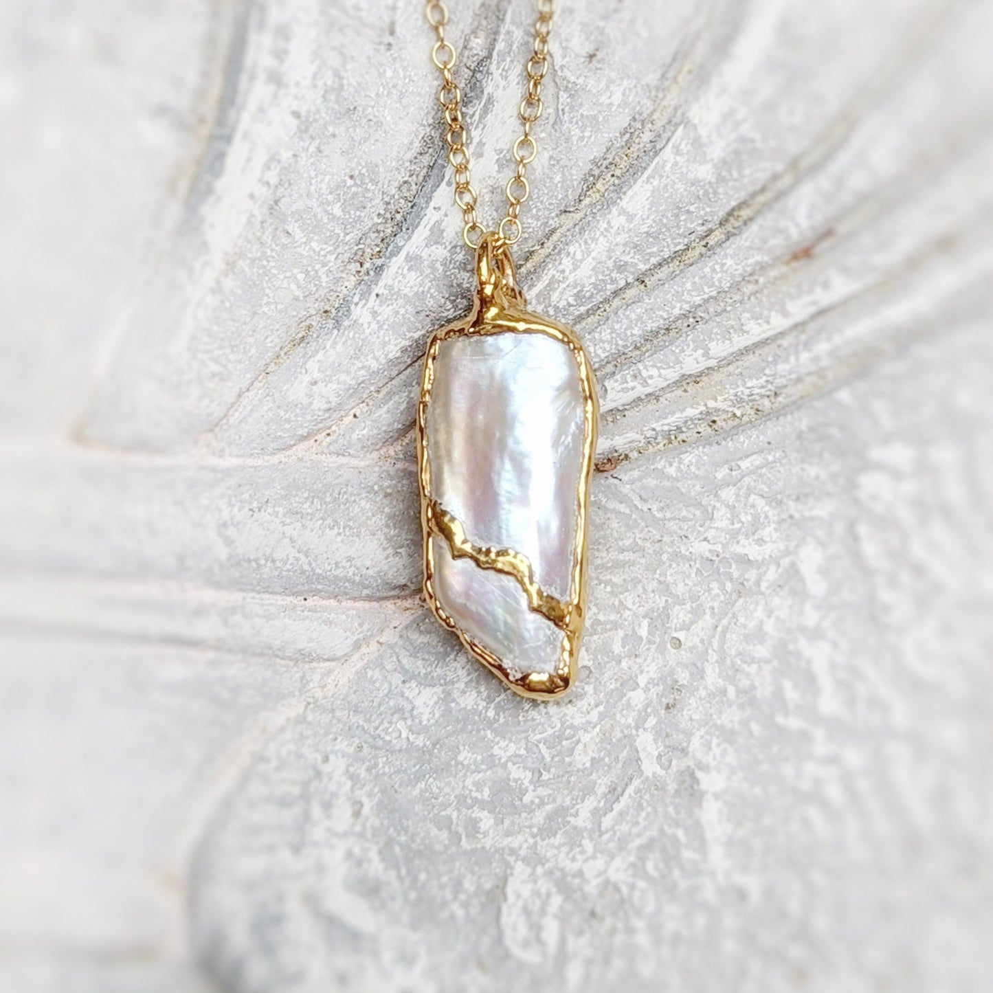 Elegant Kintsugi necklace featuring an oblong Keshi Pearl, handcrafted and plated in 18k Gold on a 21" chain.