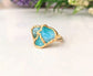Unique Aqua blue raw Peruvian Opal Kintsugi ring on a gold band, perfect for special occasions.