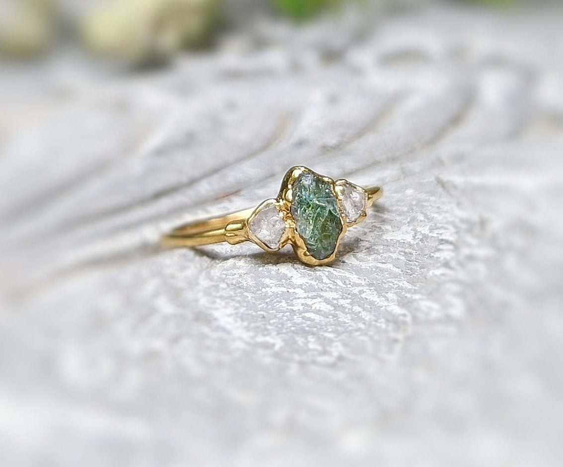 Unique raw green Sapphire and diamond engagement ring, set in 14k gold, showcasing natural gemstones.