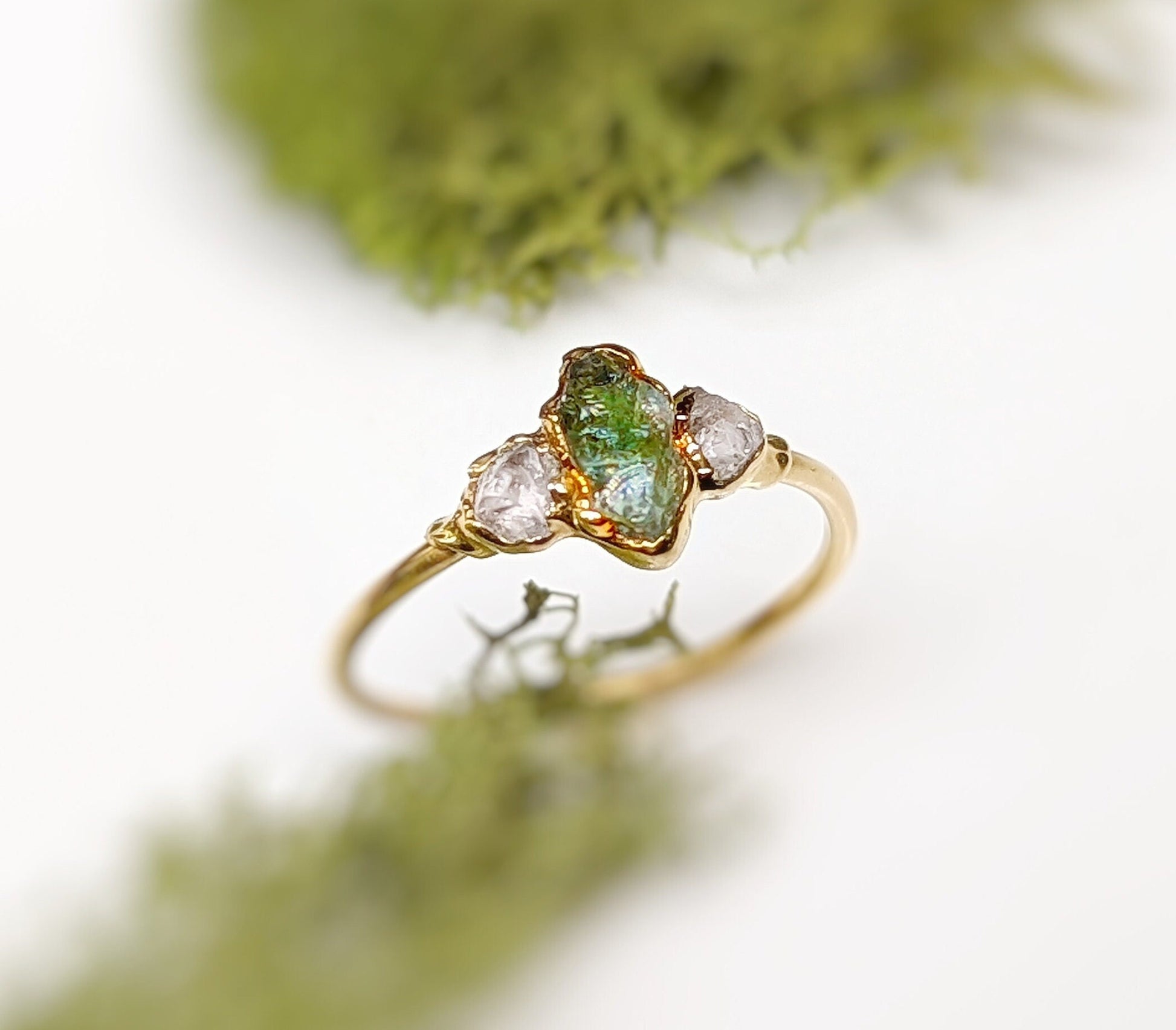 Raw green Sapphire and diamond engagement ring on gold band with natural stones, perfect for promise or gift.