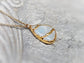 Kintsugi necklace featuring pear-shaped rainbow moonstone, electroformed with 18k gold plating on a gold-filled chain.