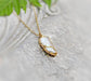 Freshwater Biwa Keshi Pearl Kintsugi necklace in 18k Gold on a textured background, perfect for gifts and special occasions.