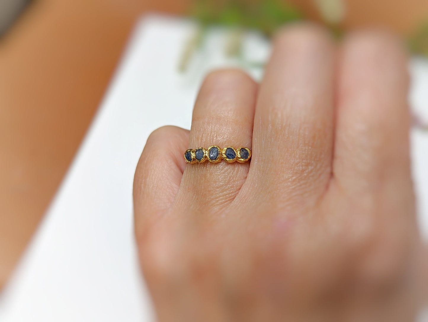 Raw Sapphire multi-stone ring on hand, featuring blue sapphires set in solid 14k gold-filled band.