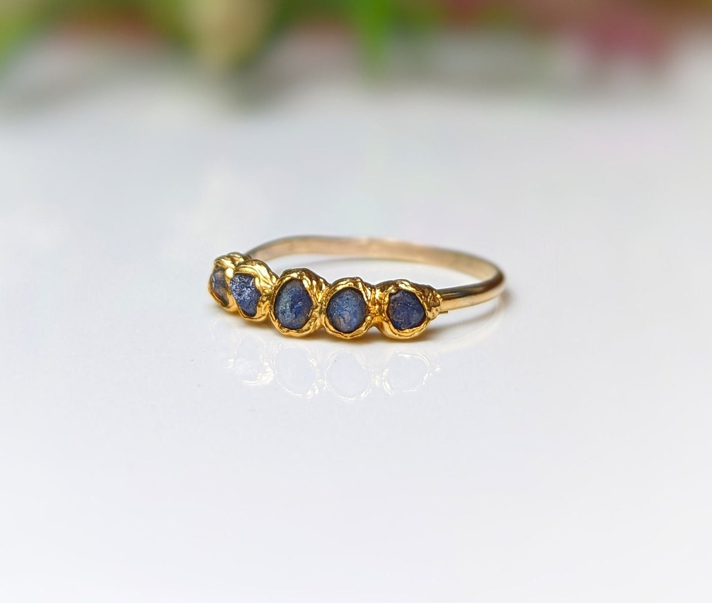 Raw sapphire multi-stone ring on solid 14k gold band, featuring 5-7 small blue sapphires, perfect for gifts and special occasions.