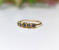 Raw sapphire multi-stone ring on solid 14k gold band, featuring 5-7 small blue sapphires, perfect for gifts and special occasions.