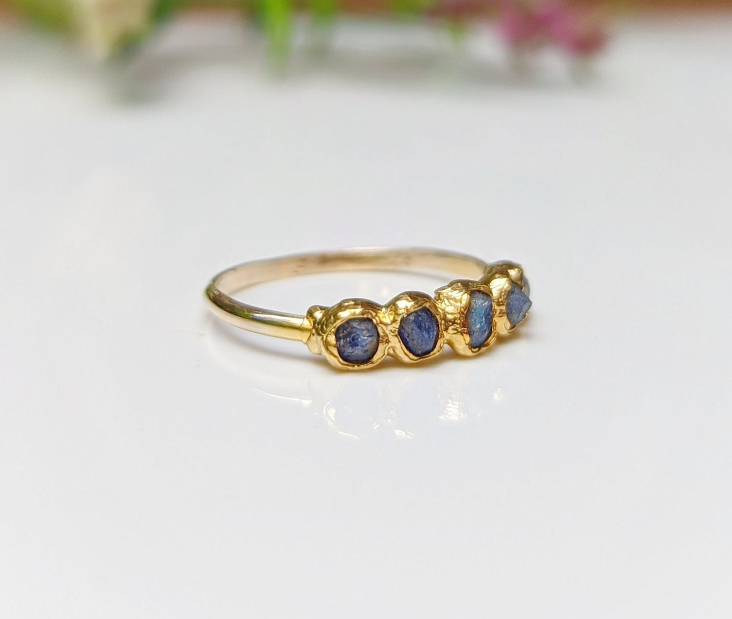 Raw sapphire multi-stone eternity ring on a solid 14k gold filled band, featuring 5-7 handcrafted blue sapphires.