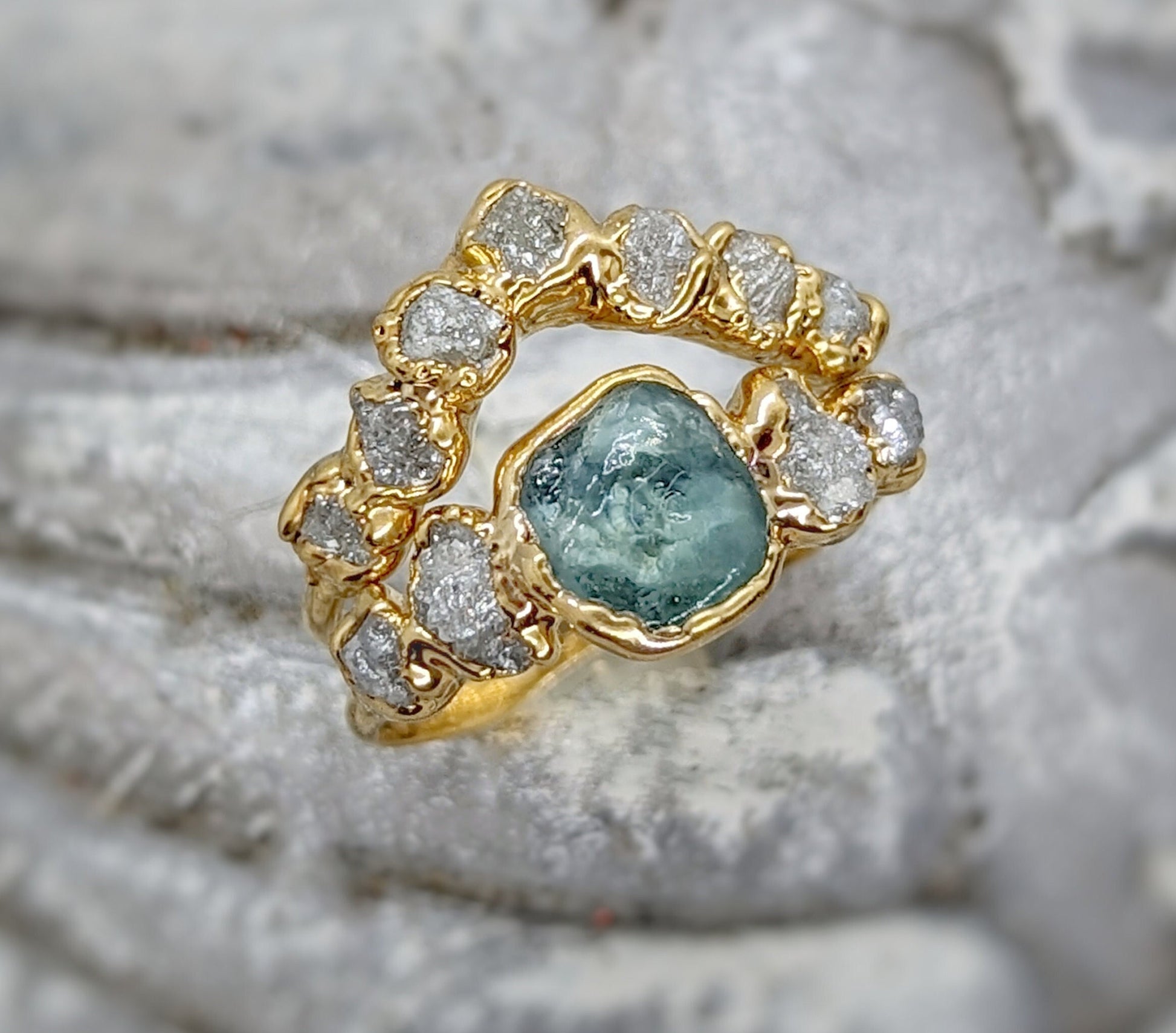Raw Montana Sapphire and diamond bridal ring set in gold, featuring a teal sapphire and conflict-free diamonds.