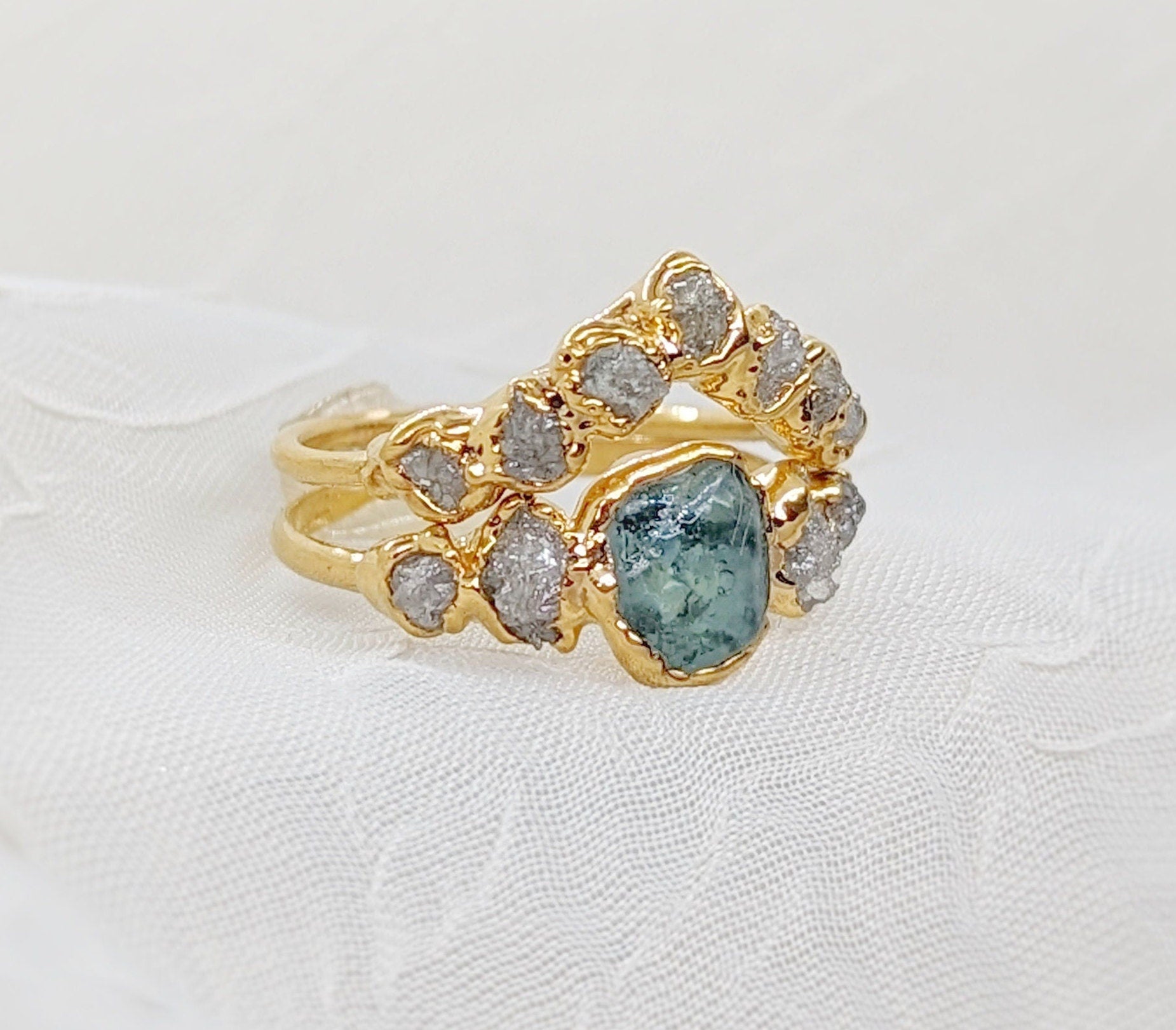 Raw Montana Sapphire and diamond wedding ring set on a 14k gold band, uniquely handcrafted for timeless elegance.