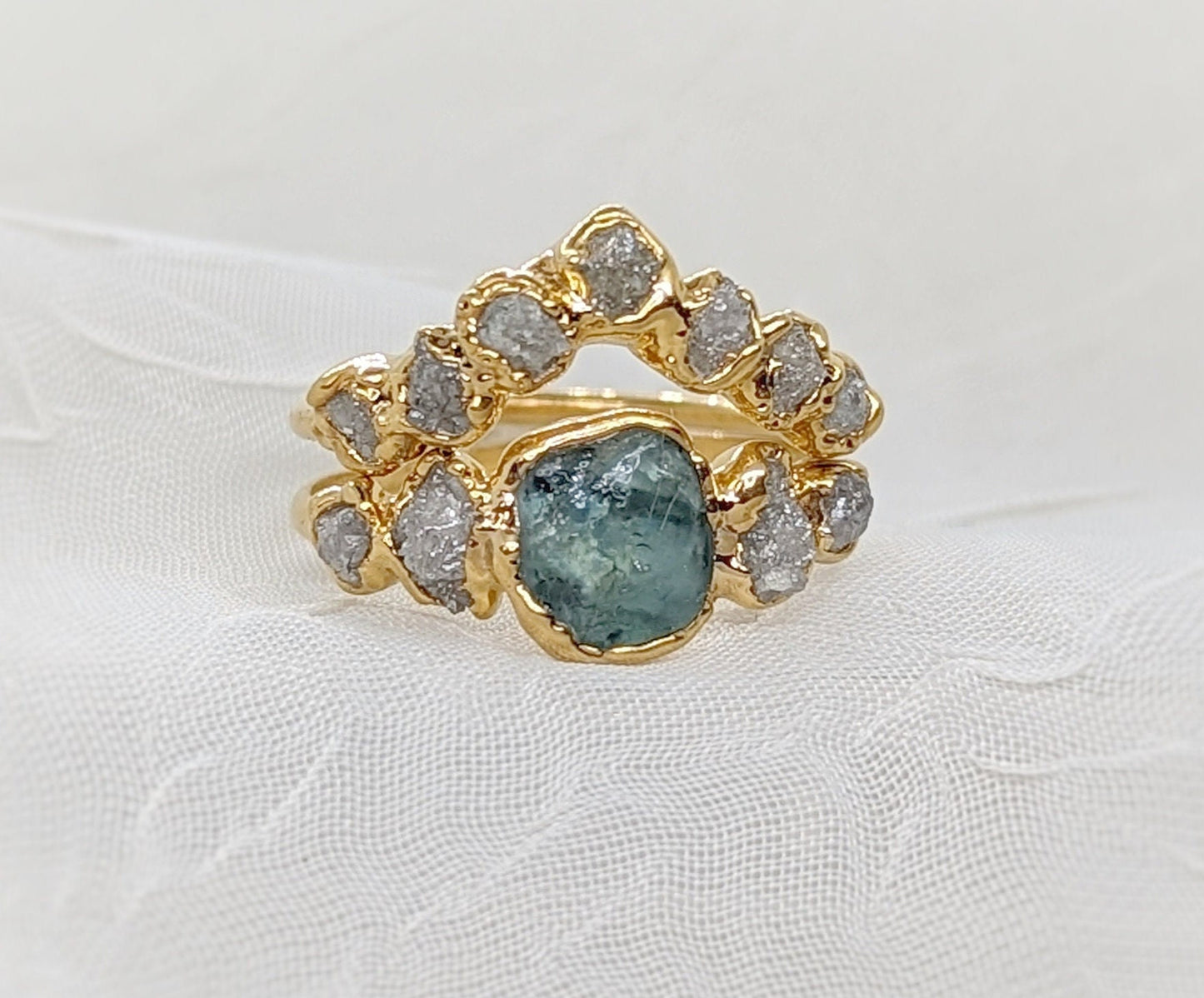 Handcrafted gold ring set featuring a raw Montana Sapphire and sparkling diamonds, ideal for unique wedding jewelry.